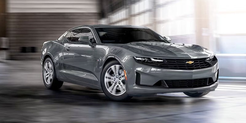 2023 Chevrolet Camaro driving through a parking garage