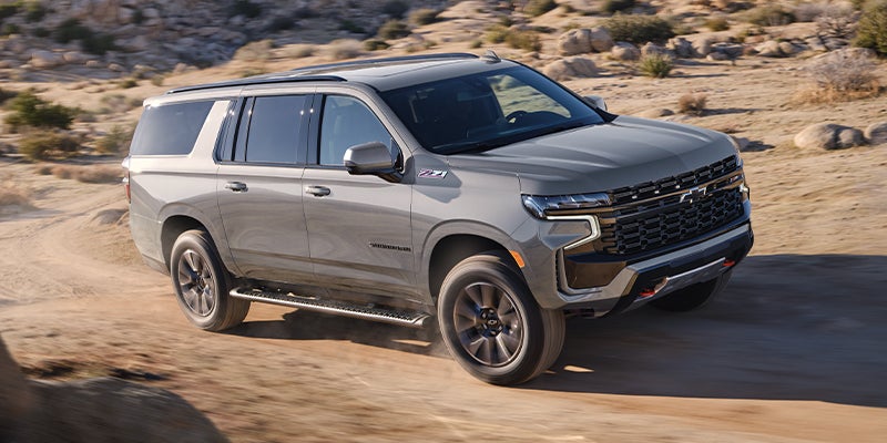 2023 Chevrolet Suburban driving on a dirt terrain